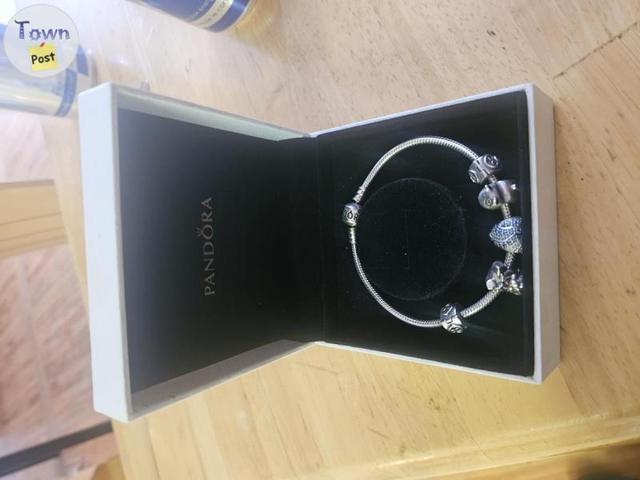 Photo of Pandora bracelet with 3 charms and 2 stoppers