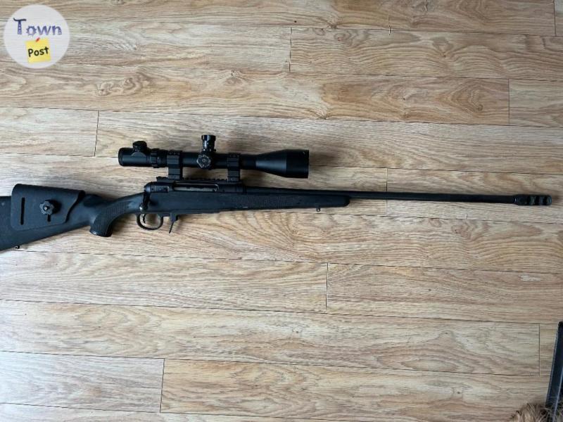 Photo of Savage 110 338 Lapua, with ammo and brass