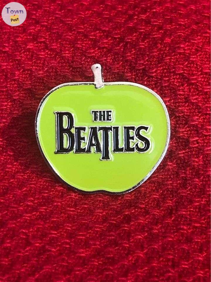 Photo of The Beatles green apple enamel pin back 1 1/4 inches.