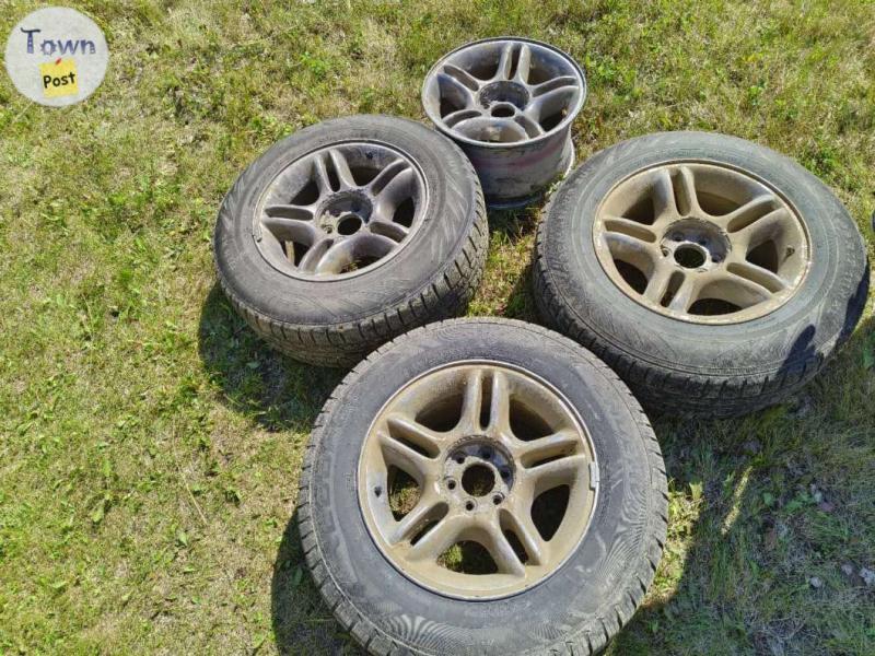 Photo of  3 SUV tires on rims  